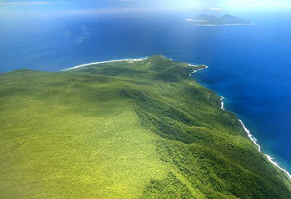 The sparsely populated Manu'a Islands are 100 km (60 mi) east of Tutuila; they include the volcanic islands of Ofu and Olosega (far distance), and Ta'u (foreground). Photo courtesy of the US National Park Service.