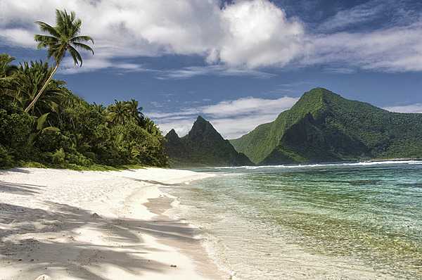 With a secluded sand beach and fringing reef, the Ofu unit of the National Park of American Samoa is an ideal place to snorkel or simply enjoy the solitude. The island of Olosega rises in the distance. Photo courtesy of the US National Park Service.