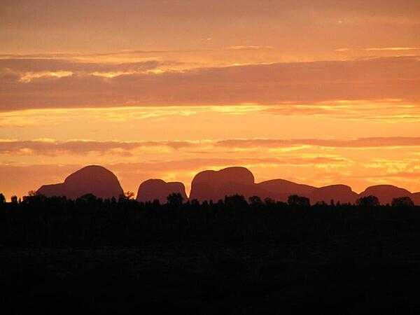 The Olgas are a magnificent mountain range located in Uluru-Kata Tjuta National Park; this is one of many beautiful sunsets over the Olgas.