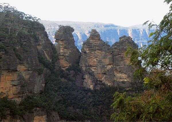 The Three Sisters are a rock formation found in the Greater Blue Mountains of New South Wales, Australia, on the north escarpment of the Jamison Valley.  Their names are Meehni 922 m (3,024 ft), Wimlah 918 m (3,011 ft), and Gunnedoo 906 m (2,972 ft). They are located close to the town of Katoomba and are one of the Greater Blue Mountains' best-known sites, towering above the Jamison Valley. The Three Sisters were formed around 200 million years ago, when volcanoes erupted through the coal, sandstone, and shale in the area. A UNESCO World Heritage Site since 2000, the Greater Blue Mountains is also home to over 400 kinds of endangered and rare animals, as well as unique plants.