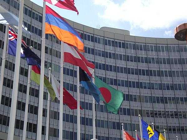 The red-white-red flag of Austria (in the center) flies with those of all the other UN countries in the entrance plaza of the United Nations Office in Vienna.