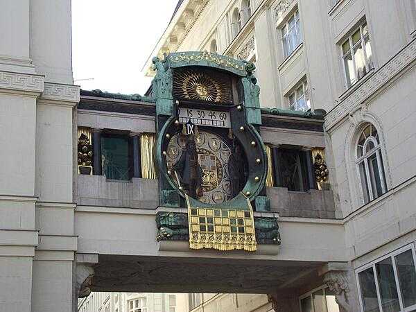 The beautiful and unique Ankeruhr (Anker Clock) overlooks the oldest square in Vienna, the Hoher Markt (Upper Market). The clock - built between 1911 and 1917 in the Jugendstil (Art Nouveau) style - forms a bridge between two buildings; it is adorned with with mosaic ornaments. Over the course of 12 hours, 12 historical figures or pairs of figures move across the bridge. Every day at noon, all of the figures parade to the accompaniment of music.