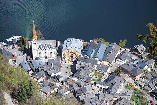 Hallstatt is a picturesque town on the shores of Hallstaetter See in the Austrian Alps and a UN World Heritage Site. There is a funicular in the town that takes one to the bluff above the city from which this "aerial" photo was taken.