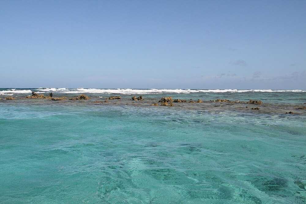 Belize is home to the second largest coral reef system in the world, after the Great Barrier Reef in Australia. The Belize Barrier Reef is a series of coral reefs 300 km (190 mi) long that became a UNESCO site in 1996. It is Belize's top tourist destination and important to the country’s fishing industry.