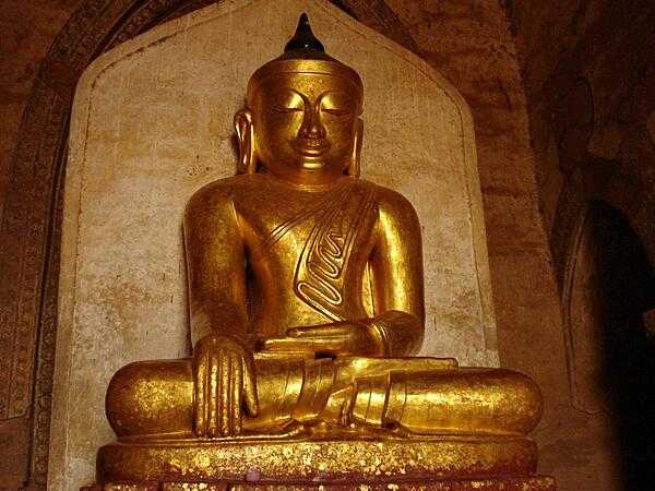 A golden Buddha statue sits in one of Bagan&apos;s many pagodas.