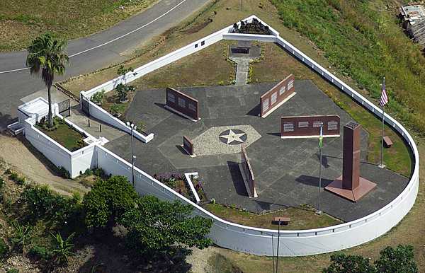 The World War II Guadalcanal American Memorial on Skyline Drive on Guadalcanal overlooks the town of Honiara and the Pacific Ocean. The site, located on the first hill occupied by US forces, honors those Americans and Allies who lost their lives during the Guadalcanal Campaign of World War II (7 August 1942 to 9 February 1943). The memorial consists of a 4-foot square, 24-foot tall pylon on which is inscribed: “This memorial has been erected by the United States of America in humble tribute to its sons and its allies  who paid the ultimate sacrifice  for the liberation of the Solomon Islands  1942-1943.” The four directional walls point to the four major battle areas. Inscribed on these walls are descriptions of the battles and a listing of the US and Allied ships that were lost. The monument was dedicated on 7 August 1992, the 50th anniversary of the American landing on Guadalcanal. Photo courtesy of the American Battle Monuments Commission.