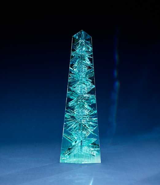 Aquamarine, often called the treasure of mermaids, is mostly found and mined in Brazil, as well as in countries that fall along the Mozambique geological belt in Africa. The biggest aquamarine ever found was in Brazil in 1910, it weighed 110 kg ( 243 lb) and was cut into smaller faceted stones for jewelry. The “Dom Pedro,” the largest single piece of cut-gem aquamarine in the world, was found in a Brazilian pegmatite mine in the late 1980s and is named after Brazil’s first two emperors (both named Pedro). The original crystal weighed roughly 45 kg (100 lb), but during excavation it shattered into three pieces. The largest section, approximately 27 kg (60 lb),  was sculpted into an obelisk shape. The obelisk,  35.5 cm (14 in) tall, measuring 10 cm (4 in) across the base and weighing 10,363 carats or 2.1 kg (4.6 lbs), is part of the permanent collection of Smithsonian National Museum of Natural History in Washington, DC. Photo courtesy of the Smithsonian/ Greg Polley.