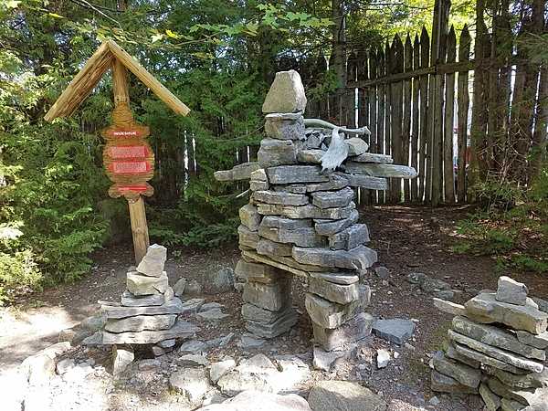 Inukshuks or structures of rough stones stacked in the form of human figures traditionally used by Inuit people as a landmark or a commemorative sign  - at the replica Wendat (Huron) village outside Quebec City.