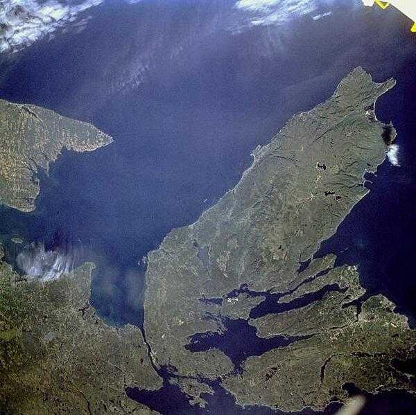The Canadian maritime province of Nova Scotia can be divided into two separate regions - Cape Breton Island (on the right) and much larger, peninsular mainland Nova Scotia (lower left). Cape Breton Island is joined to the mainland by a causeway and a railroad spanning the narrow Strait of Canso. St. George&apos;s Bay is the small bay west of the causeway, and the Northumberland Strait separates Cape Breton Island from the eastern end of Prince Edward Island, another maritime province of Canada (visible along the west margin of the photograph). Photo courtesy of NASA.