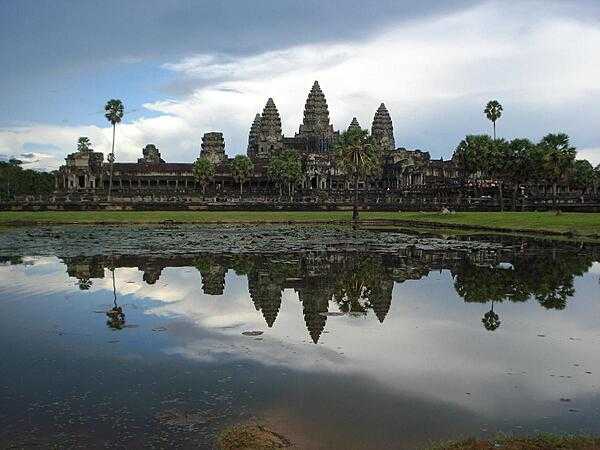 View of the main Angkor Wat temple complex reflected in a pool. The central towered portion appears on the Cambodian flag.