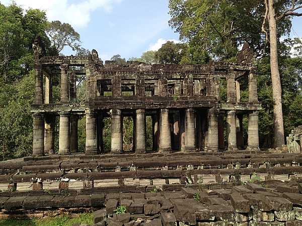Preah Khan is a temple located northeast of Angkor Thom, it was built in the 12th century for King Jayavarman VII to honor his father. Preah Khan remains largely unrestored, with numerous trees and other vegetation growing among the ruins. The purpose of this two-story building with round columns is unknown, but it is referred to as "the library."