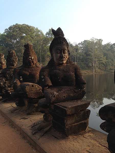 Serene statues on a bridge at the South Gate at Angkor Thom.