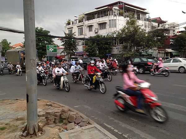 Busy street in Phnom Penh where motorcycles are a very common form of transportation.