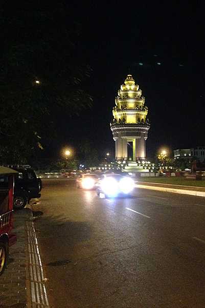 Cambodia’s Independence Monument is brightly lit at night.