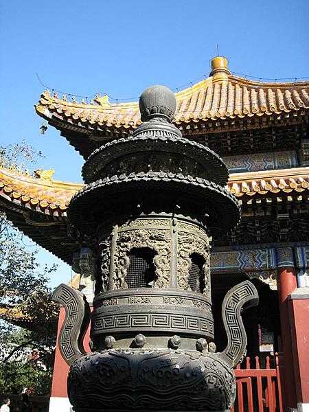 The Lama Temple in Beijing was originally built in 1694 to house court eunuchs. Sometimes called the Palace of Peace and Harmony, it now serves as a Buddhist monastery. This pavilion and the incense burner in the foreground are part of the Temple complex.