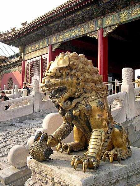 A gilded lion sits before the Palace of Tranquil Longevity in the Inner Court of the Hall of Supreme Harmony in the Forbidden City.