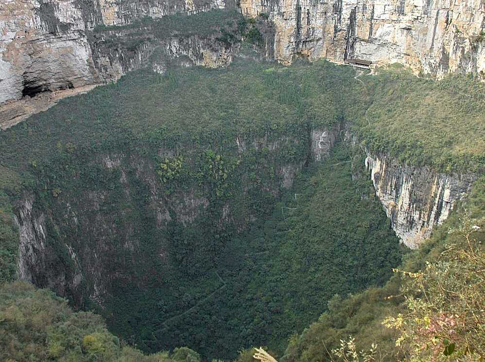 The Xiaoxhai Tiankeng is the world’s largest and deepest sinkhole at 660 m deep (2,165 ft), with a volume of 130 million cu m (4.6 billion cu ft). Located in southwestern China, the tiankeng, which means “heavenly pit” in Mandarin, was discovered in 1994. It is a unique double-nested sinkhole that holds two craters joined by a sloping edge, and during the rainy season, a waterfall cascades from the mouth of the pit to an underground river and cave network below.