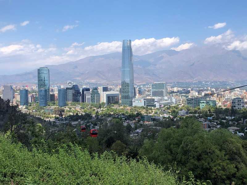 Torre Costanera is one of the largest buildings in the southern hemisphere. The Metropolitan Park provides a nice view of the gondolas and the business center of Santiago, Chile.