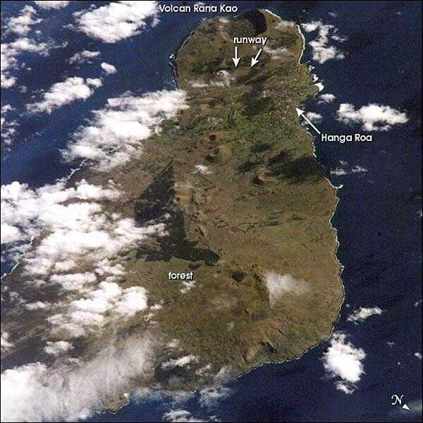 View of Easter Island (Rapa Nui) from space. The island is one of the most remote locations on Earth, being more than 3,200 km (2,000 mi) from the closest populations on Tahiti or Chile. Easter Island is perhaps most famous for the giant stone monoliths, known as moai, that have been placed along the coastline. Archaeologists believe the island may have been discovered and colonized by Polynesians as early as A.D. 700. Subsequently, a unique culture developed. The human population grew to levels that could not be sustained by the island. A civil war resulted, and the island&apos;s deforestation and ecosystem collapse was nearly complete. Today, a new forest (primarily eucalyptus) has been established in the center of the island (dark green). Less than 25 km (15 mi) long, the geography of the island is dominated by volcanic landforms, including the large crater Rana Kao at the southwest end of the island and a line of cinder cones that stretch north from the central mountain. A final feature (difficult to see) is the very long runway (Chile&apos;s longest) near Rana Kao, which served (but was never used) as an emergency landing site for the Space Shuttle. Image courtesy of NASA.