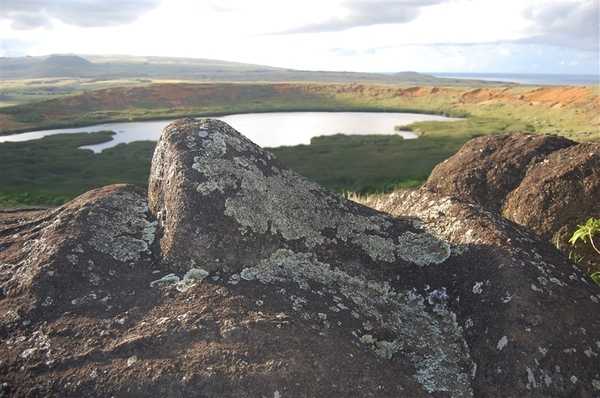 Lichen-covered rocks overlook a small volcanic crater lake and marsh on Easter Island (Rapa Nui). Image courtesy NOAA / Elizabeth Crapo.