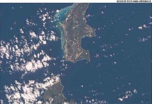 A view of two of the Mariana Islands as seen from the space shuttle - the south of Saipan and the northern tip of Tinian. Image courtesy of NASA.