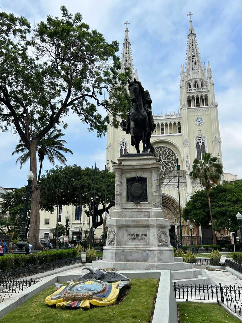 In the heart of downtown Guayaquil, Ecuador, is Parque Seminario, better known as Iguana Park for the dozens of iguanas that call it home.  The picture shows the park's statue of Simon Bolivar and, in the background, adjacent to the park is Metropolitan Cathedral.  The cathedral is the successor to the church that was located here when the city was originally founded in the 16th century.