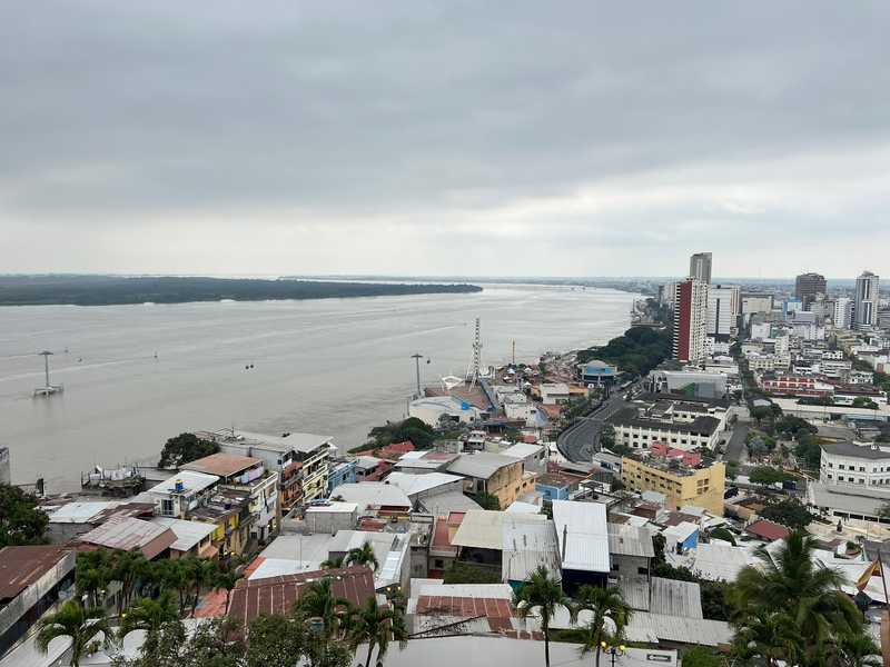 From the top of the Las Penas overlook in Guayaquil, Ecuador, you can see the Babahayo River as it flows to the Pacific Ocean. The colonial center of Guayaquil sits along the river. A cable car system was built to ferry commuters and tourists across the river.  The newly constructed river walk provides a strip of parkland along the river with shops and museums.