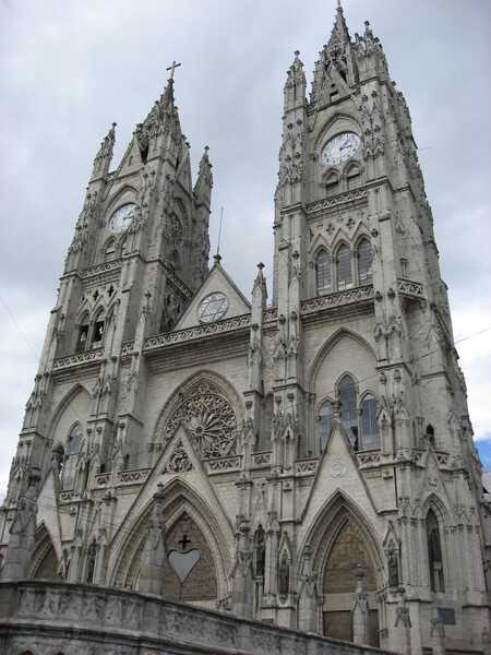 The front facade of the Basilica of the National Vow (Basílica del Voto Nacional) in Quito. The Catholic church is meant to serve as a perpetual reminder of the consecration of Ecuador to the Sacred Heart. Groundbreaking took place in 1892 and the formal consecration occurred in 1988. Technically the basilica remains unfinished, since, according to local legend, its completion would signal the end of the world.  The edifice is the largest Neo-Gothic basilica in the Americas.