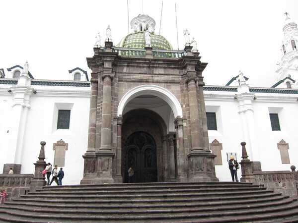 The Quito Metropolitan Cathedral was first built between 1535 and 1545 but was subsequently reconstructed and enhanced over the centuries; it is the seniormost Catholic church in the country. The photo shows the "Arch of Carondelet" entrance (built in 1797) and its staircase.