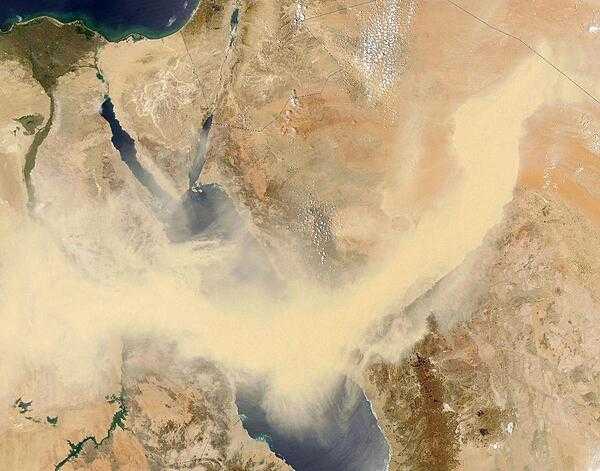 A thick snake of tan dust slithers across Saudi Arabia, the Red Sea, and Egypt in this dramatic true-color image from 13 May 2005. The dust is so thick that it is completely opaque for well over 1,100 km (700 mi) across its south-moving front, from the border of Iraq, across the Arabian Desert of Saudi Arabia, and eastern Egypt and the green ribbon of the Nile. Click on photo for higher resolution. Image courtesy of NASA.
