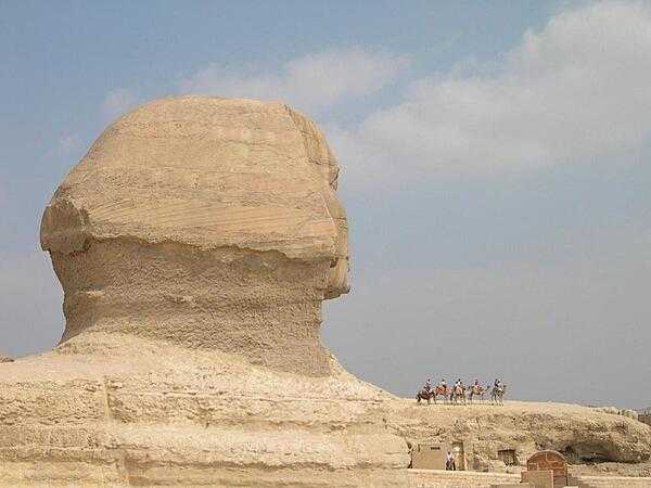 The immensity of the Sphinx becomes apparent when it is compared to a camel party riding along one of its paws.