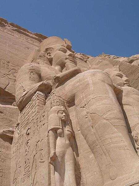 A closer view of one of the statues of Ramses at Abu Simbel shows Nefertari, his wife, at his knee.
