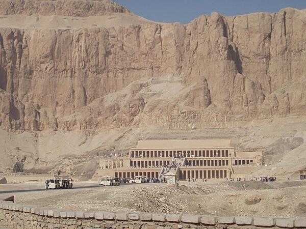 Mortuary Temple of Hatshepsut at Deir al-Bahri showing high cliffs in the background.