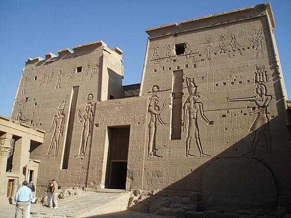 The second pylon of the Temple of Isis on the island of Philae in the Nile near Aswan. This is the entrance to the temple. The original Philae Island was flooded by the waters of Lake Nasser behind the Aswan High Dam. The island of Agilqiyya was reconfigured to have similar topography to the old island of Philae and is sometime referred to as the New Philae Island. The Temple of Isis was moved to the island to escape the rising waters of the lake.