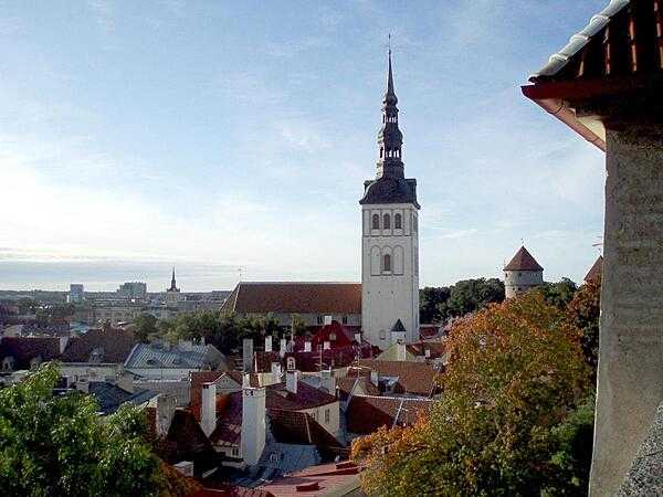 Rooftop view of the lower town of Tallinn as seen from the upper town. The prominent church is that of Saint Nicholas, originally built in the 13th century. Partially destroyed by Soviet bombing during World War II, the church was restored and is today used as an art museum and concert hall.