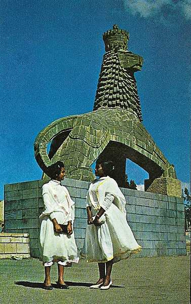 Two ladies in national dress in front of the Lion of Judah Monument in Addis Ababa.