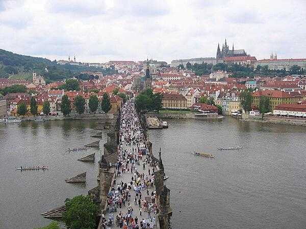 The bustling, pedestrian-friendly Charles Bridge as viewed from the tower on the Stare Mesto (Old Town) side of the structure. The bridge is 516 m long and almost 10 m wide and rests on 16 arches shielded by ice guards. Thirty statues of saints decorate the bridge avenue; most were originally erected between 1683 and 1714, but then replaced with replicas beginning in 1965. The originals are currently housed in the National Museum.