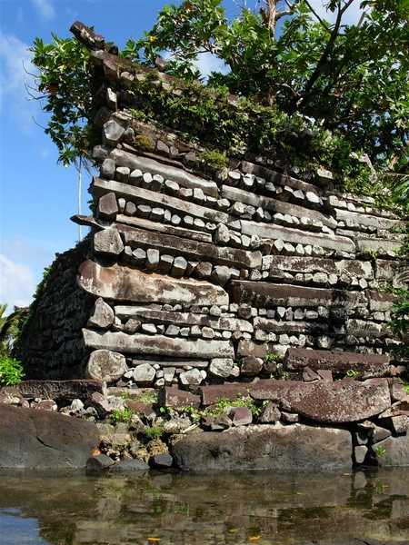 Close up of one of the most prominent stacked-log towers in Nan Madol gives a very good idea of the crisscross-stacking process that was used in building construction. Image courtesy of NOAA.