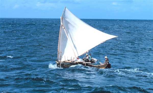 A Micronesian outrigger under sail. Photo courtesy of NOAA / James P. McVey.