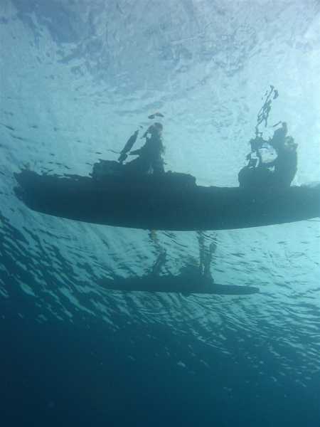 Outrigger canoe as seen from below passing over dive team. The bottom image is the outrigger and is actually farther from diver. Photo courtesy of NOAA / Dwayne Meadows.