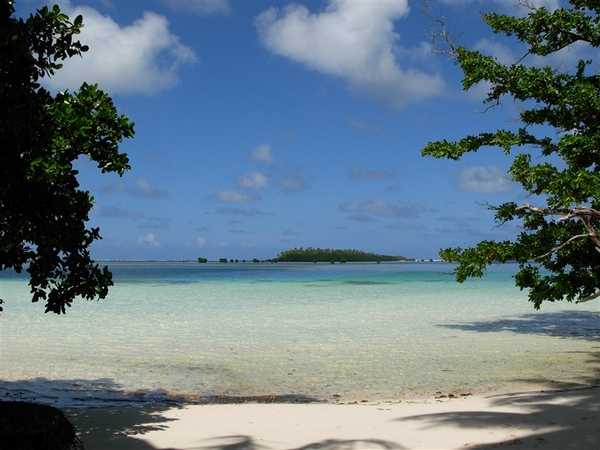 A picture of serenity: white sand beach, a tropical lagoon, and small islets. Photo courtesy of NOAA / Lt. Cmdr. Matthew Wingate.