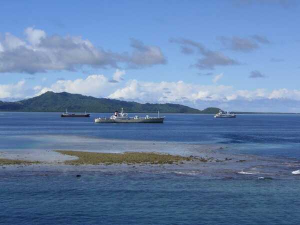 A view of the lagoon of Pohnpei Island with the outer reef in the foreground. The lagoon offers a good anchorage outside of Pohnpei harbor. Factory ships often anchor in the lagoon to process fish brought in by fishing boats.