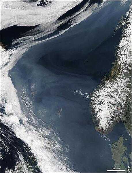 Grayish white over the deep blue Norwegian Sea, a thick cloud of  smoke drifts north off the western coast of Norway in this image, taken on 7 May 2006, by NASA&apos;s Aqua satellite. The smoke is coming from hundreds of fires burning in western Russia, most of which are probably agricultural fires. By the time this image was taken, smoke had lingered over the Norwegian Sea for more than a week as the fires continued to burn. In this image, hazy skies extend from Denmark, lower right, west to Iceland, upper left. The densest of the smoke hangs over the Shetland Islands (lower center) and the Faroe Islands (left center). The northern shores of Great Britain are in the lower left corner of the image. Photo courtesy of NASA.