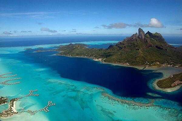 Bora Bora from the air; over-water bungalows in lower left.