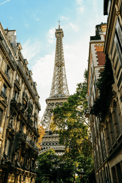 A view of the Eiffel Tower framed by a row of Parisian buildings in summer. 
The 7th arrondissement of Paris is one of the 20 arrondissements of the capital city of France. Called Palais-Bourbon, in a reference to the seat of the National Assembly, the arrondissement includes some of the major and well-known tourist attractions of Paris, such as the Eiffel Tower, the Hôtel des Invalides, the Musée d'Orsay, and Musée Rodin.  Situated on the Rive Gauche - the "Left" bank of the River Seine - this central arrondissement is home to many foreign diplomatic embassies.