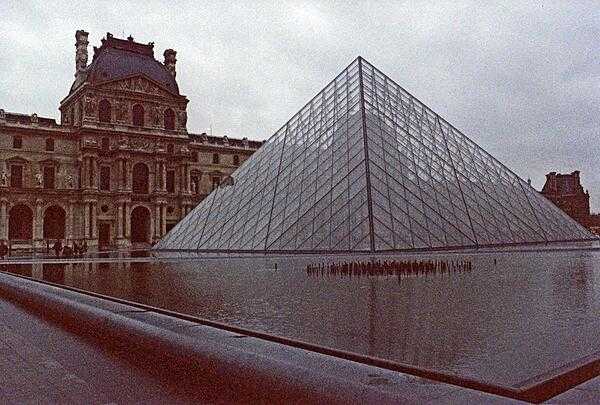 There are an estimated 95,000 museums in the world and the largest one is the Louvre in Paris, France.  This view of the museum features the Paris Pyramid at the main entrance. Designed by I.M.Pei and completed in 1988 as part of the Grand Louvre project, they pyramid enlarged the museum for visitors and the collection. Constructed of glass and metal, the structure stands 21.6 m (71 ft) tall and replicates the Great Pyramids of Giza.