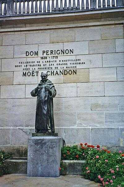 The French Benedictine monk Dom Pérignon (1638-1715) made many important contributions to the production and quality of champagne wines as a way to offset his monastery’s financial difficulties. He studied how to avoid explosions during the refermentation, advocated harvesting grapes in small crops in cool conditions before sending them to the press, and popularized using naturally occurring processes in winemaking. Wines bearing his name sold for twice as much as others, making it the first time in economic history someone successfully used their own name and personality as a marketing tool. In 1937, Moët & Chandon bought the brand name Dom Pérignon for their prestige cuvée, as well as the remains of the Abbey of Hautvillers in Epernay where the monk lived. This statue stands outside the gate.