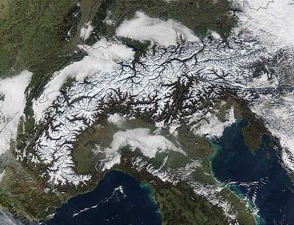The Alps march across this image of Autumnal (early October) southern Europe. On either side of and above the Alps are the countries of (from left to right) France, Switzerland, Liechtenstein, Austria, and Slovenia, while below the Alps is Italy. The Mediterranean and Ligurian Seas sit to the west of Italy, while to the right is the Adriatic Sea. As the season progresses, snow begins to whiten the Alps. Image courtesy of NASA.