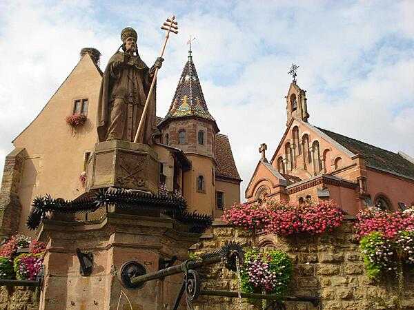 The Church of Saint Peter and Saint Paul, the Chapel of Saint-Leo IX, and the statue of Saint-Leo IX in Eguisheim.