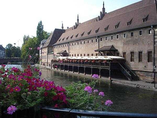 The old custom&apos;s building (L&apos;Ancienne Douane) on the Grande Ile in Strasbourg. Constructed in 1358, the structure housed the port and tax authorities, and was used to store and transform goods and merchandise going up and down the Rhine River. Today the building houses a restaurant.
